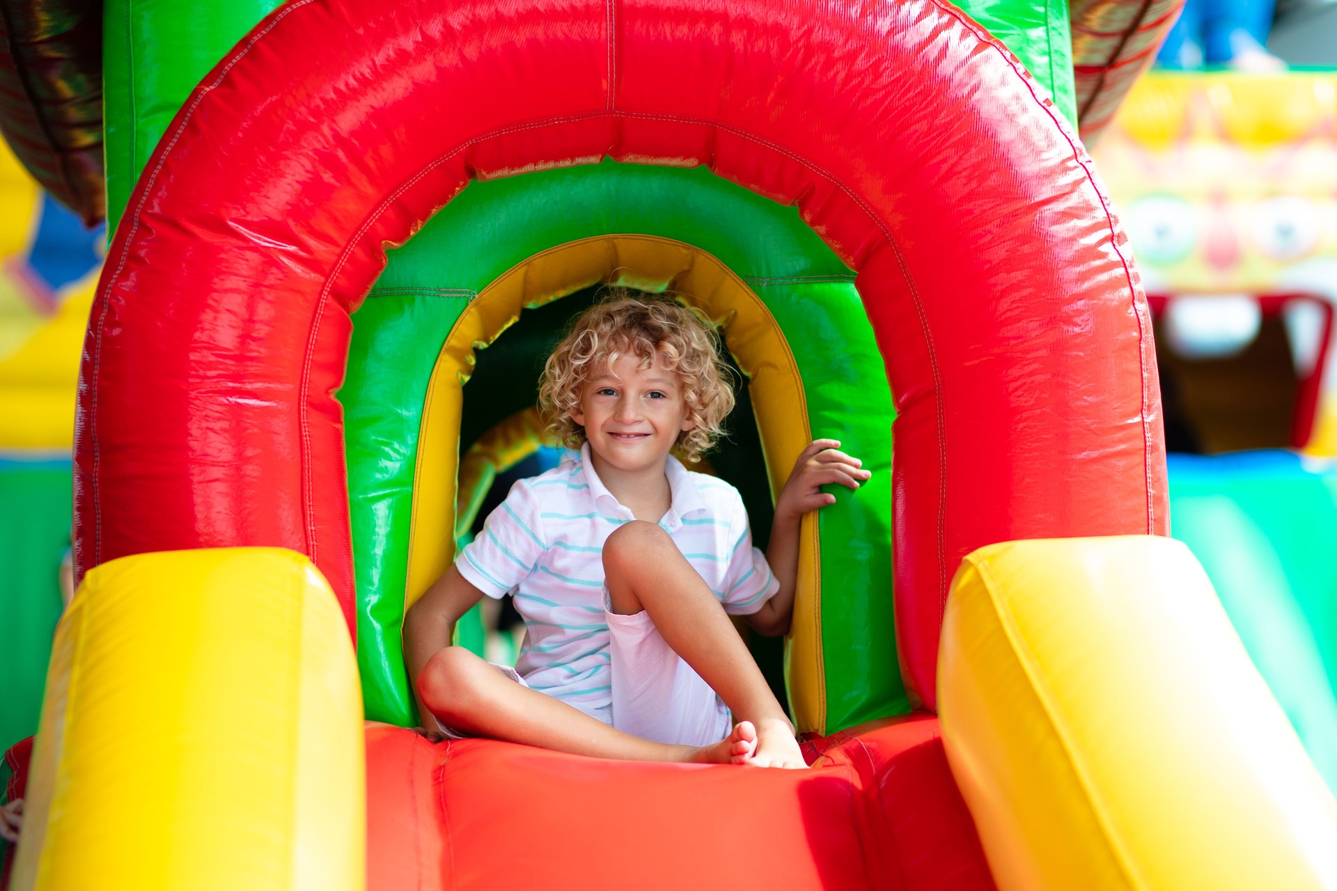 Child jumping on playground trampoline. Kids jump.